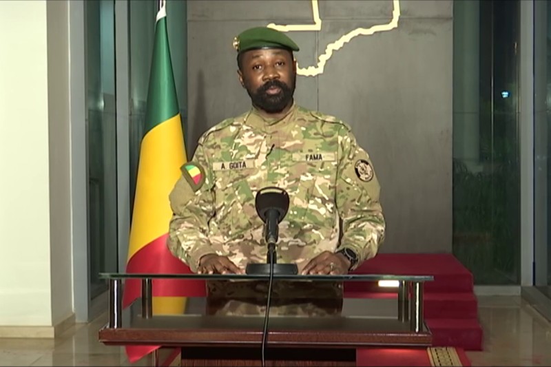 Colonel Assimi Goita, Mali's military leader, speaks at a podium with the Malian flag behind him
