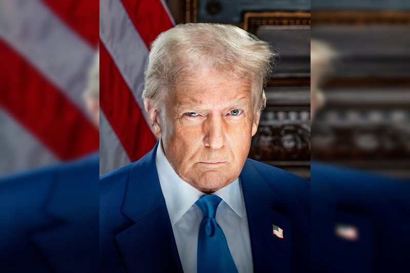 Official 2025 inaugural portrait of President Donald Trump in a blue suit with an American flag in the background