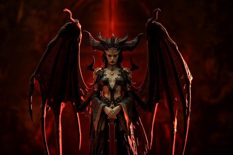 A demonic figure with horns and bat-like wings stands against a dark red smoky background, evoking the Diablo franchise aesthetic