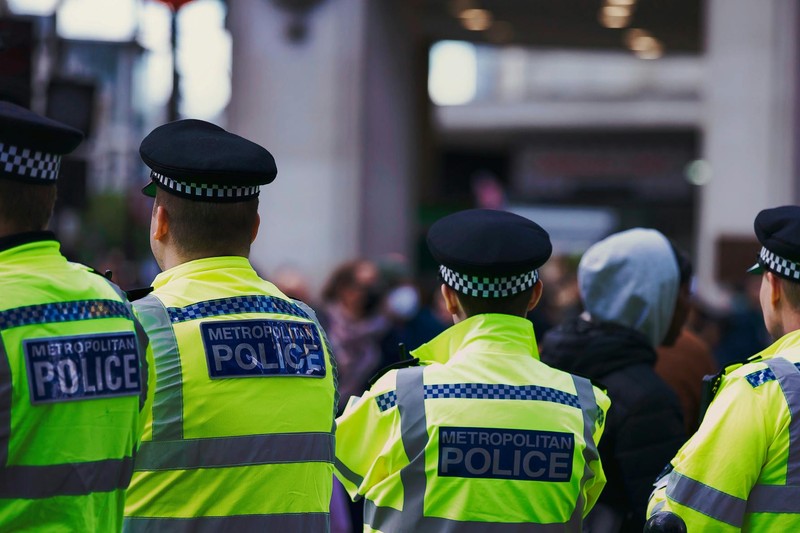Metropolitan Police officers in high-visibility jackets on patrol in London