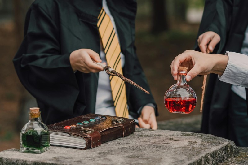 Wizards in robes crafting potions on a stone altar with spell books and wands