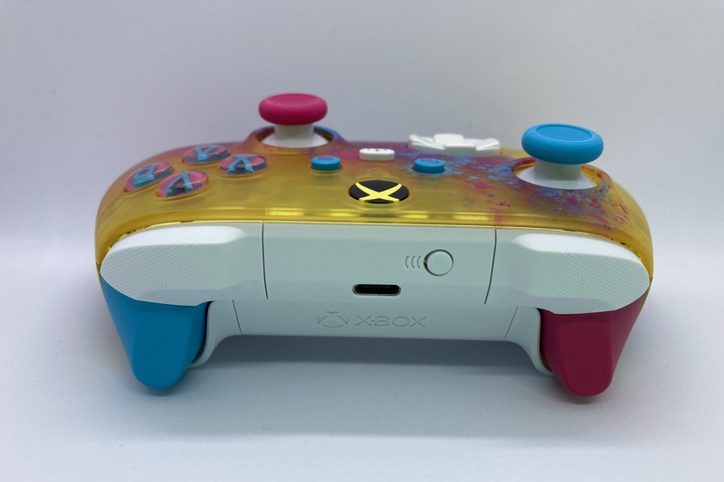 A special-edition Forza-branded Xbox Series X|S controller with translucent yellow top panel, white body, and blue and red grips