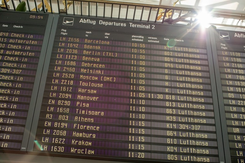 Airport departure board displaying Lufthansa flight schedules and destinations at Terminal 2