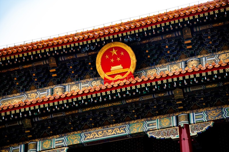 Chinese national emblem displayed on ornate traditional building in Beijing
