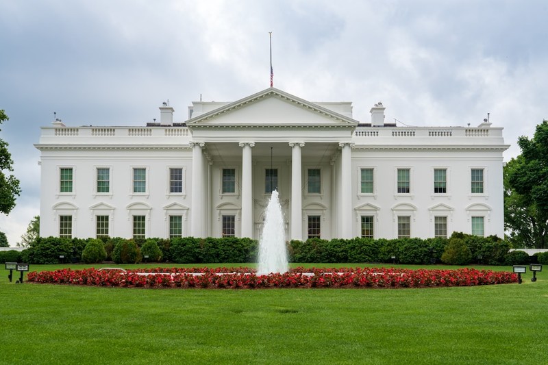 The White House in Washington, D.C., with a fountain and manicured lawn in the foreground
