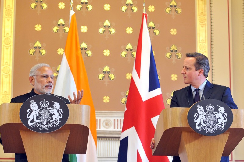 Indian Prime Minister Narendra Modi at a press conference with British flags and podiums in the background