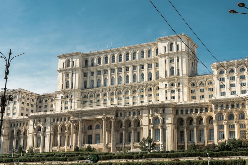 The Palace of the Parliament in Bucharest, Romania, under clear blue skies