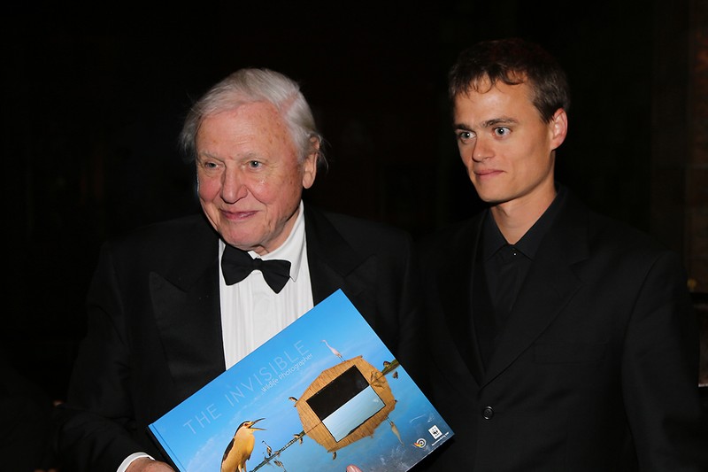 Sir David Attenborough holding a wildlife photography book at the BBC Wildlife Photographer of the Year competition at the Natural History Museum in London