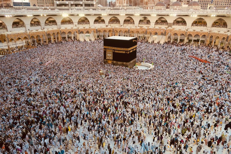 Aerial view of thousands of pilgrims in white ihram surrounding the Kaaba at the Grand Mosque in Mecca during Hajj