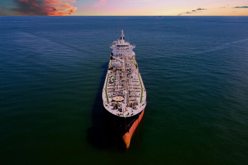 Aerial view of a large oil tanker sailing on the open ocean at sunset