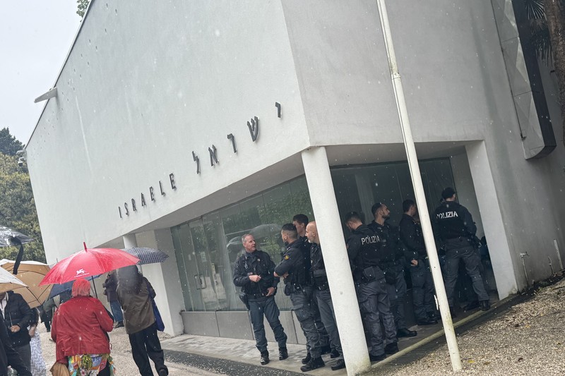 Police officers stationed outside the Israeli Pavilion at the Venice Biennale during a rainy day