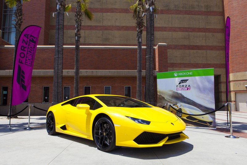 A yellow Lamborghini Huracán displayed at a Forza promotional booth at E3 2014