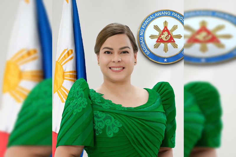 Official portrait of Sara Duterte, Vice President of the Philippines, standing beside the Philippine flag and the Vice Presidential seal