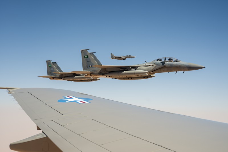 Royal Saudi Air Force F-15SA fighter jets flying in formation against a clear blue sky