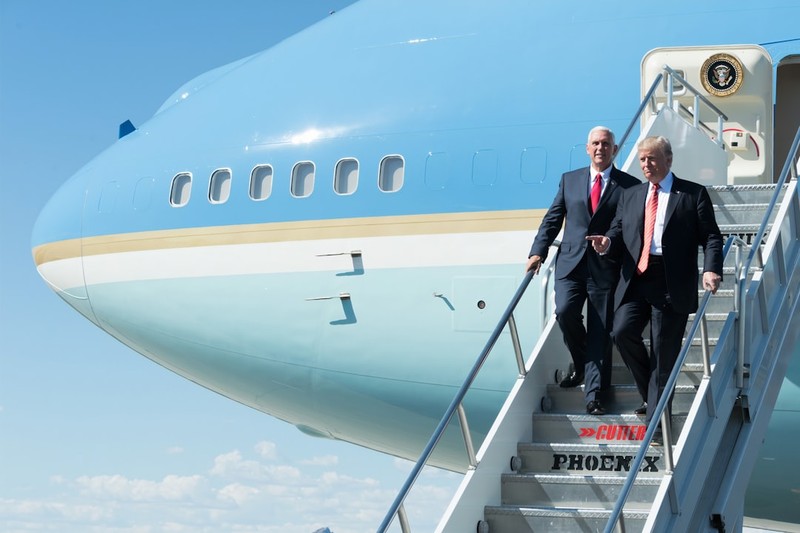 President Donald Trump and Vice President Mike Pence descend the stairs of Air Force One