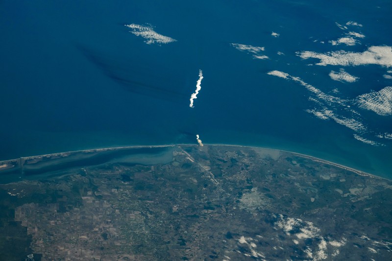 SpaceX Starship 6 launch plume rising over the Gulf of Mexico coastline as seen from the International Space Station