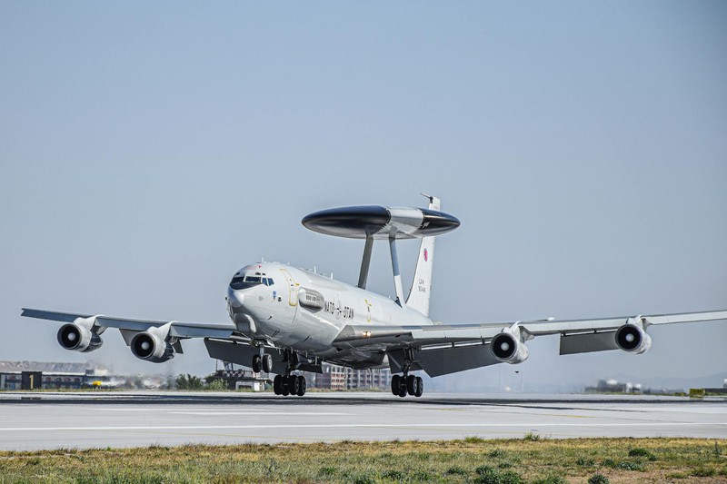 NATO AWACS E-3 Sentry surveillance aircraft on a sunlit runway preparing for takeoff