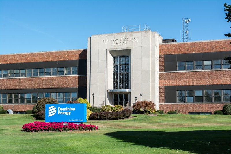 The Dominion Energy office building in Cleveland, Ohio, with prominent company signage and landscaped grounds under a clear blue sky.