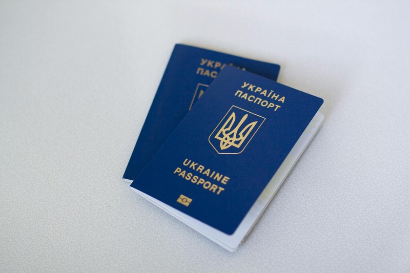 Two blue passports resting on a light surface, close-up view