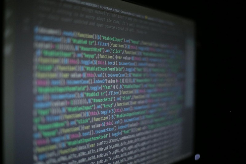 Close-up of syntax-highlighted programming code displayed on a dark computer monitor