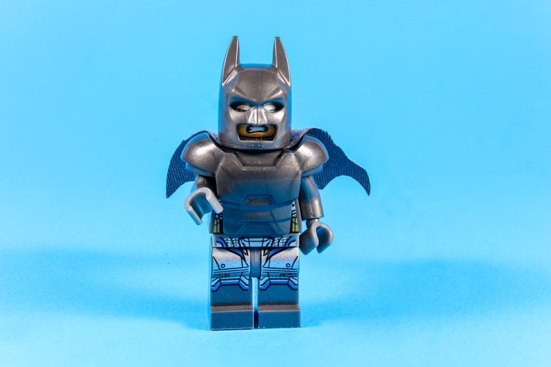 LEGO Batman minifigure in armored suit against a bright blue background