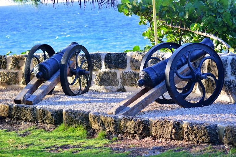 Historical cannons overlooking the Atlantic Ocean at a coastal fortification in Barbados