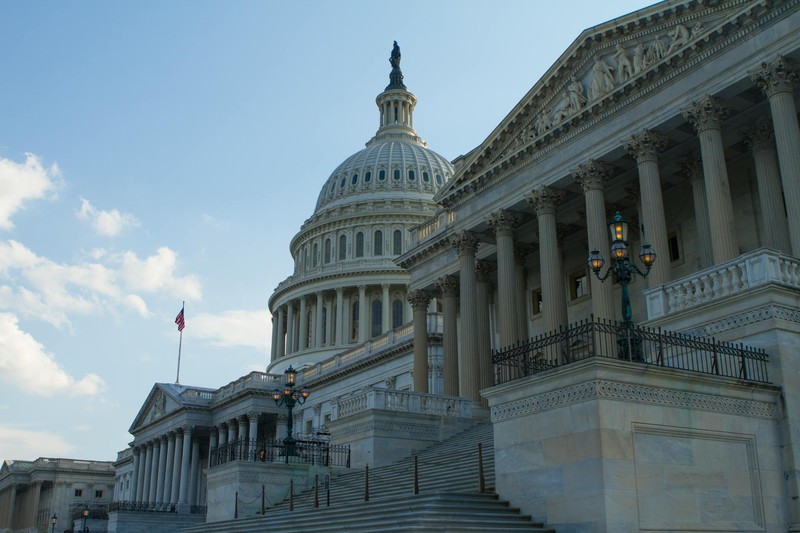 The United States Capitol Building in Washington, DC, with its iconic dome under a clear blue sky