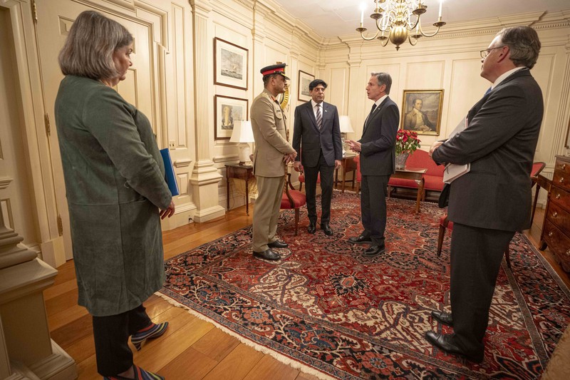 U.S. and Pakistani officials hold a formal diplomatic meeting in a ornate reception room at the State Department
