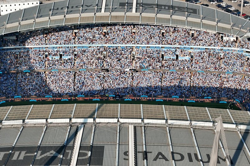 Aerial view of Etihad Stadium packed with Manchester City fans in blue