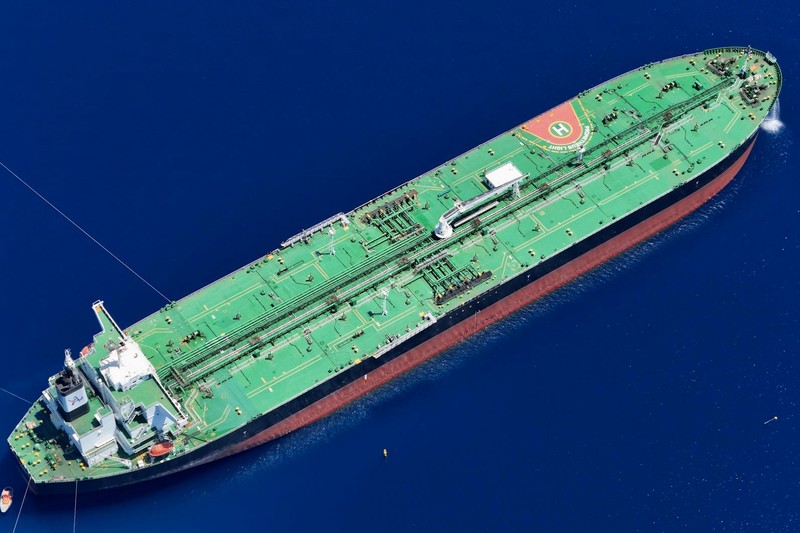 Aerial view of a large oil tanker sailing through open ocean waters