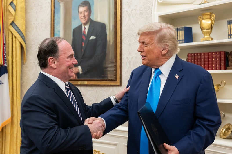 President Donald Trump shaking hands during a ceremony in the Oval Office of the White House