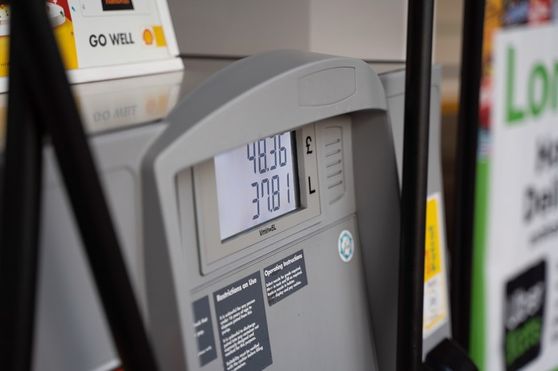 Close-up of a gas pump digital display showing fuel cost and volume at a filling station