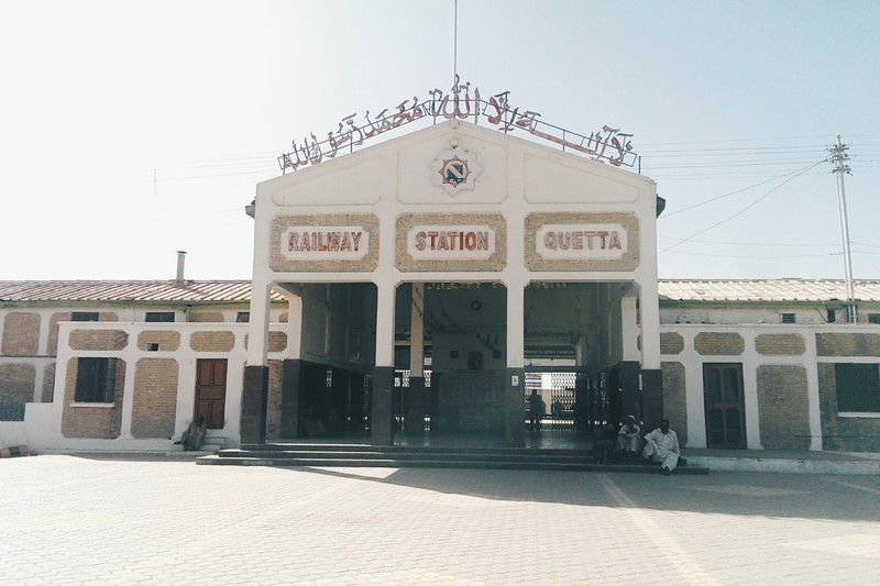 Quetta Railway Station exterior view showing arched portico with bilingual English and Urdu signage
