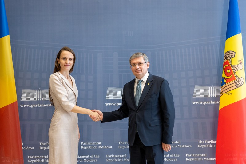 Romania's Foreign Minister Oana-Silvia Țoiu during a diplomatic meeting at the Parliament of the Republic of Moldova, with Romanian and Moldovan flags visible