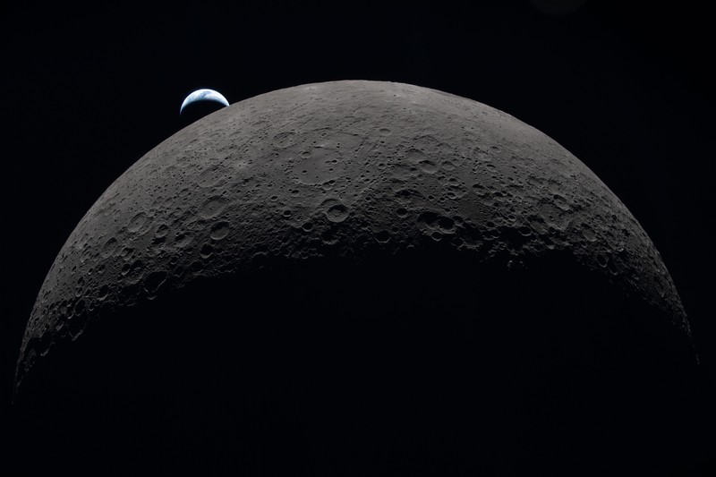 Earth sets over the Moon's curved limb as seen from the Artemis II spacecraft