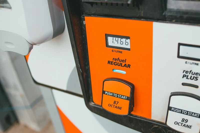 Close-up of a gas pump display showing fuel prices and octane selection buttons