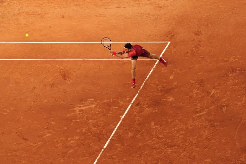 Novak Djokovic plays a shot on clay at Roland-Garros during the French Open