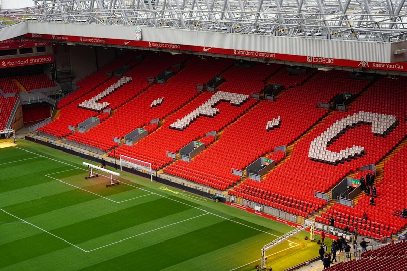 Anfield Stadium with empty red seats and LFC lettering visible in the stands