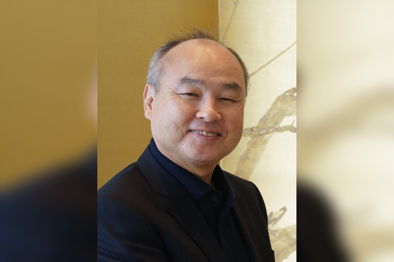 Portrait of SoftBank Group CEO Masayoshi Son smiling at SoftBank headquarters in Tokyo, 2025.