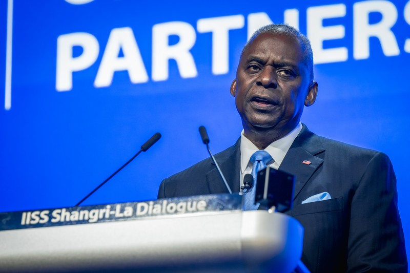 A defense official delivers remarks at the IISS Shangri-La Dialogue podium