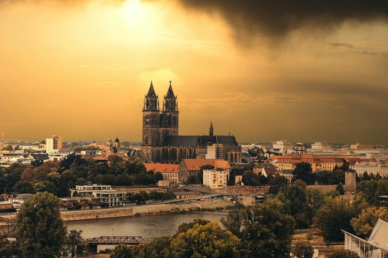 Magdeburg Cathedral silhouetted against dramatic sunset skies over the Saxony-Anhalt capital