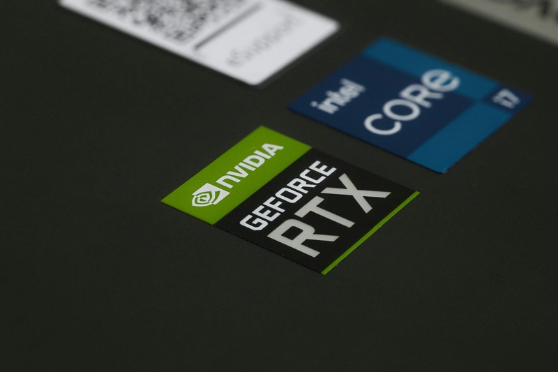 Close-up of NVIDIA GeForce RTX and Intel Core stickers on a laptop surface