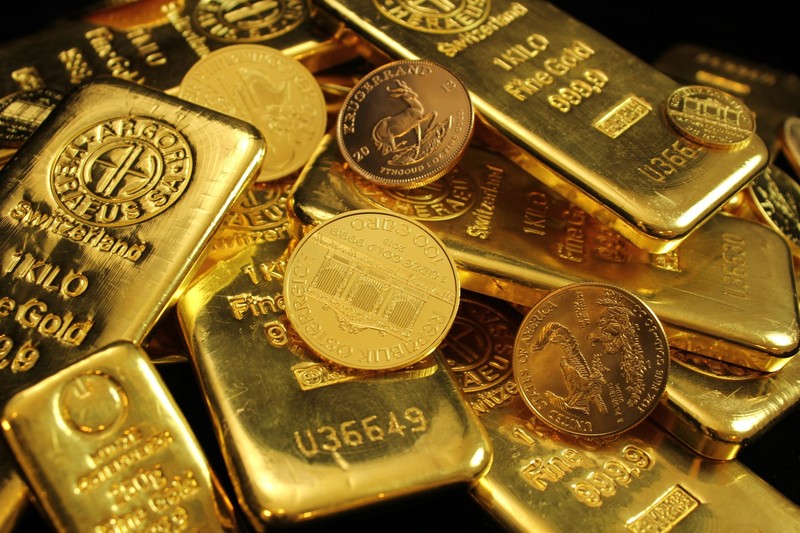Close-up of gold bars and coins with fine gold purity markings