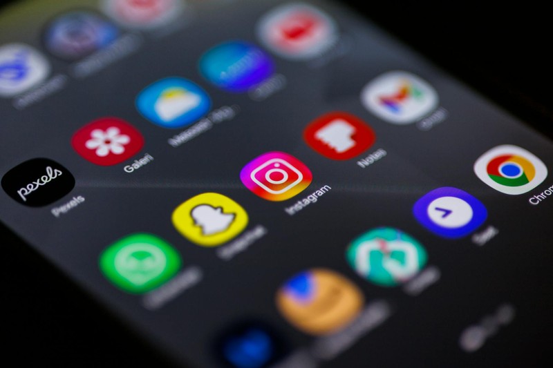 Smartphone screen showing Instagram app icon in sharp focus among other social media apps